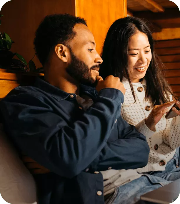Couple sitting on their phone